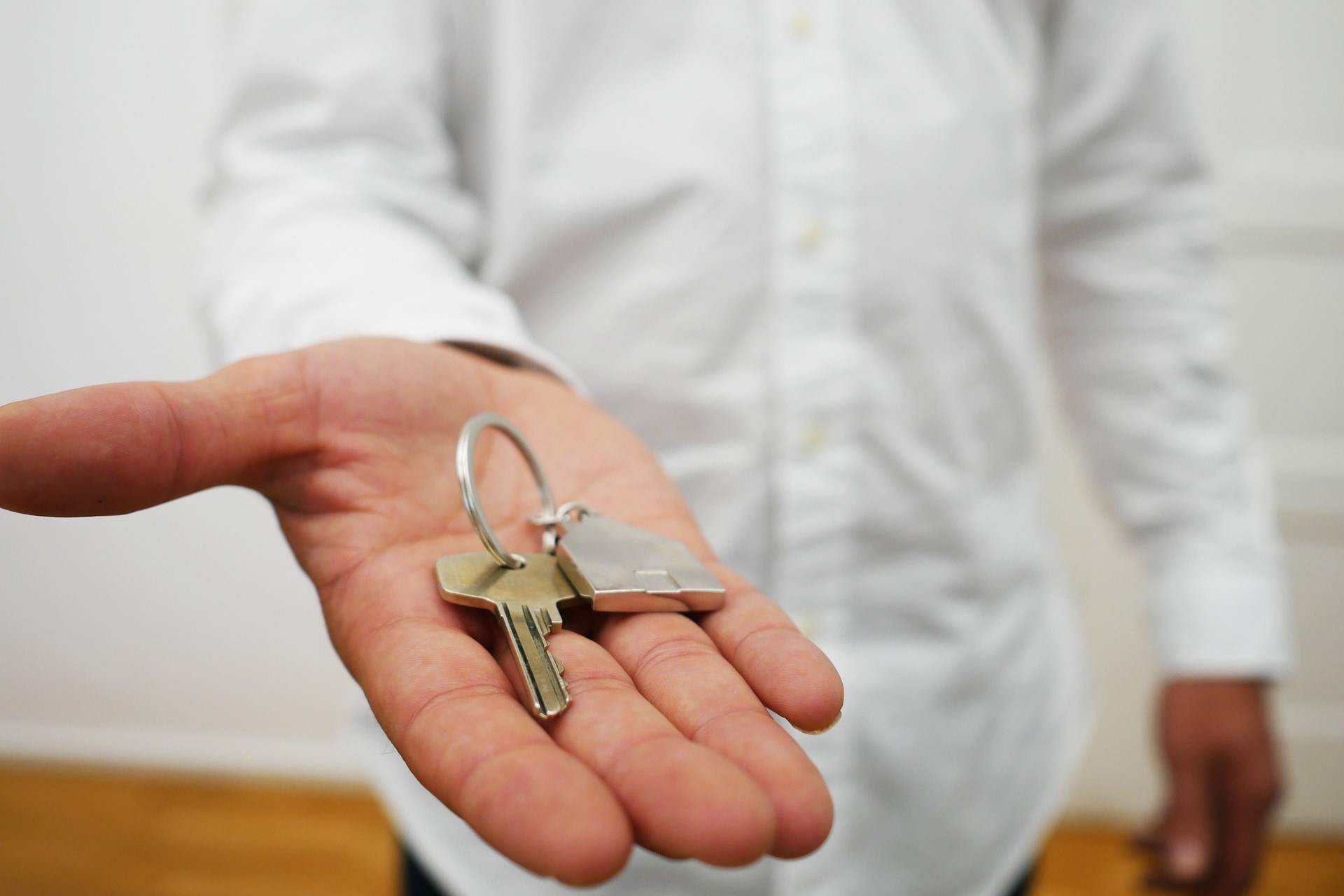 Family receiving keys in front of their new home.